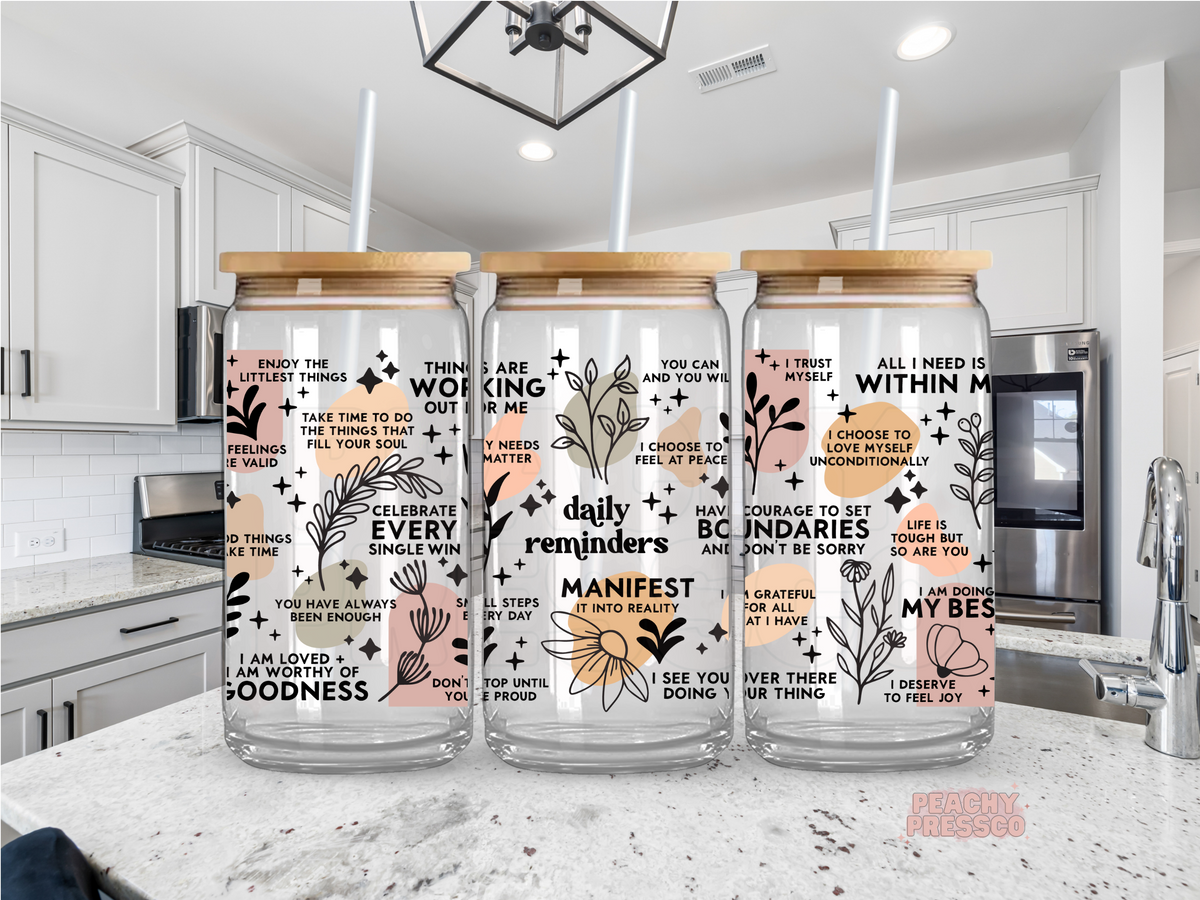 Inspirational daily reminders 16oz glass cup with positive affirmations, floral artwork, bamboo lid, and reusable glass straw.
