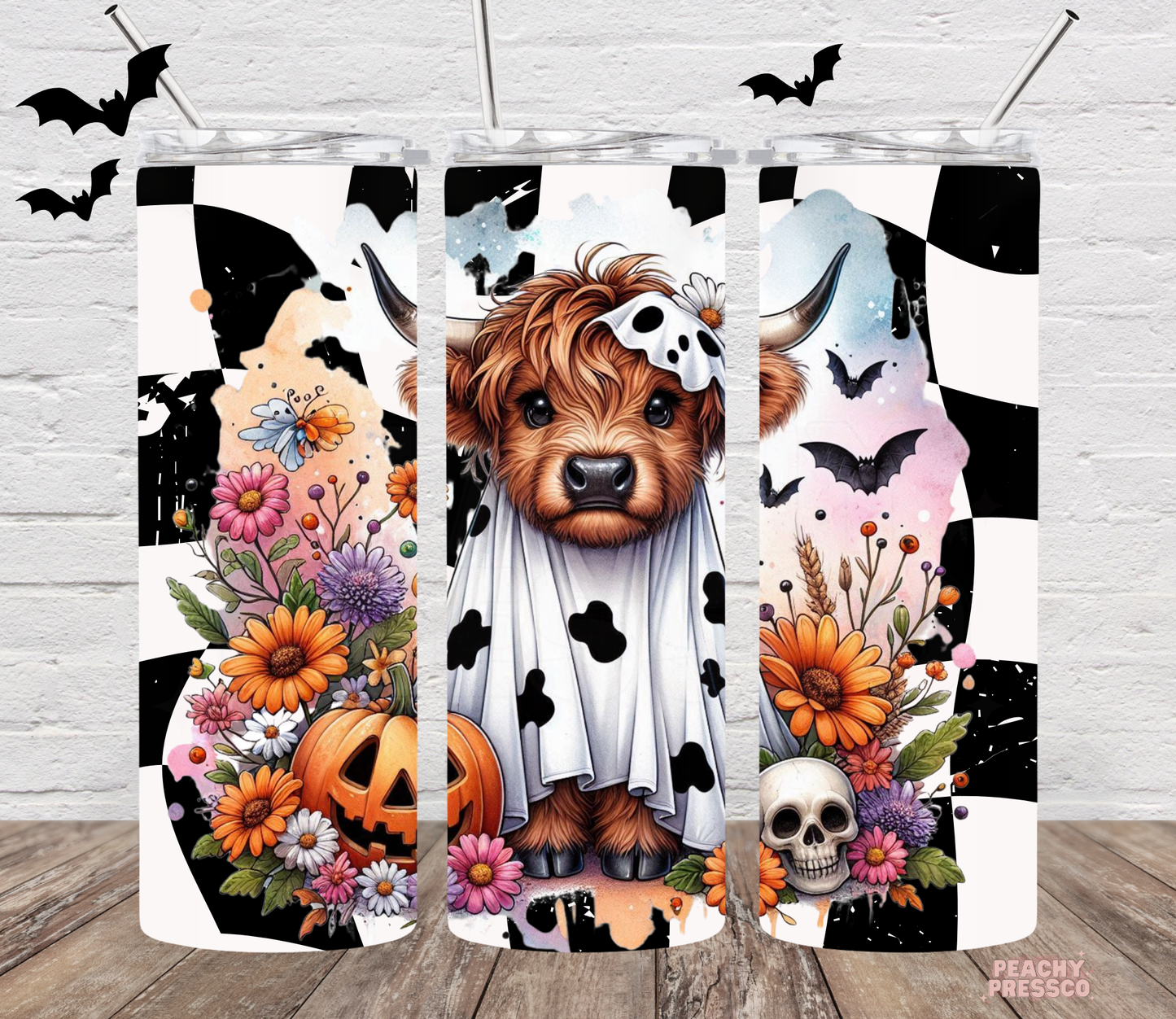20oz skinny tumbler featuring a Highland cow dressed as a ghost with pumpkins, flowers, skull and Halloween accents.