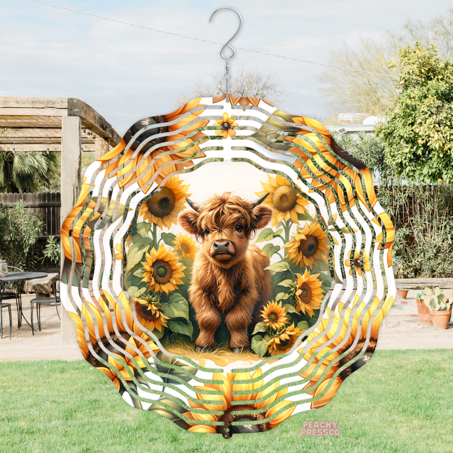 Rustic metal wind spinner featuring a fluffy Highland cow surrounded by bright sunflowers, ideal for farmhouse, country, and garden décor.
