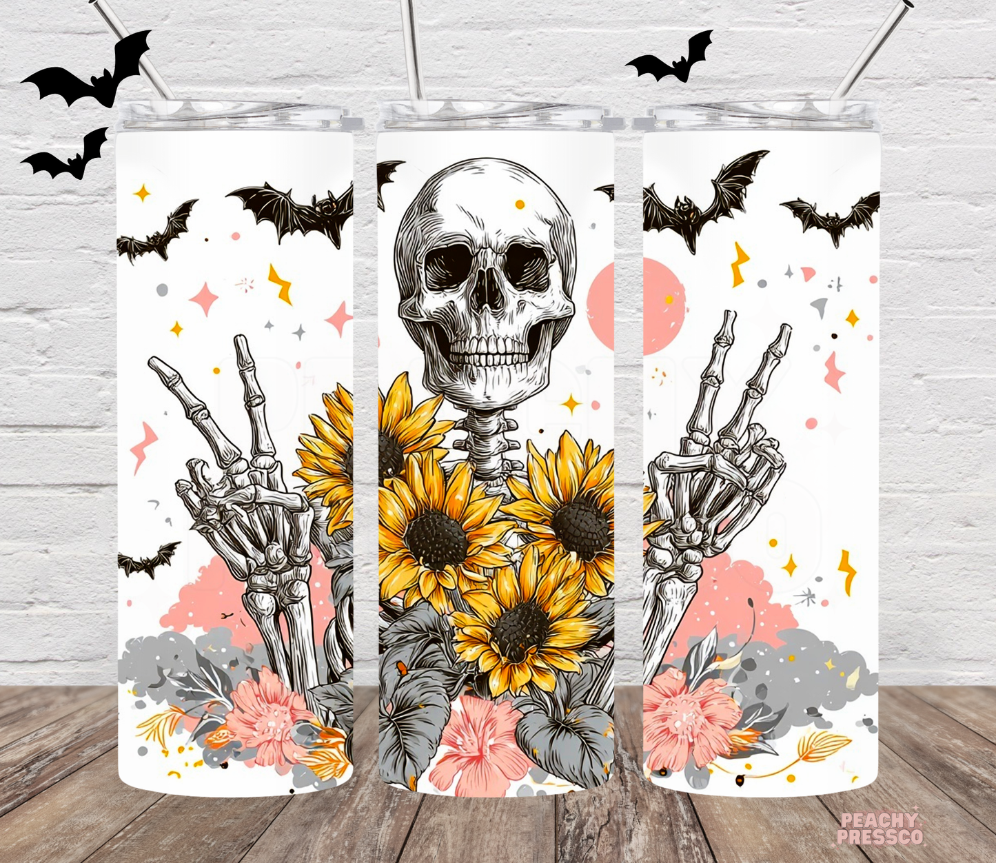 20oz skinny tumbler with skeleton, peace sign hand, sunflowers, bats and floral Halloween artwork.
