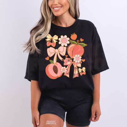 Woman wearing a black oversized t-shirt with feminine peach and floral graphic featuring bows and hearts.