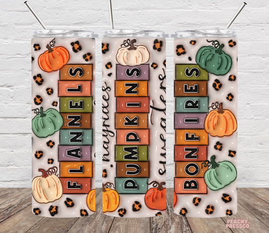 Decorative wall art with autumn-themed text and pumpkins on a white brick background.