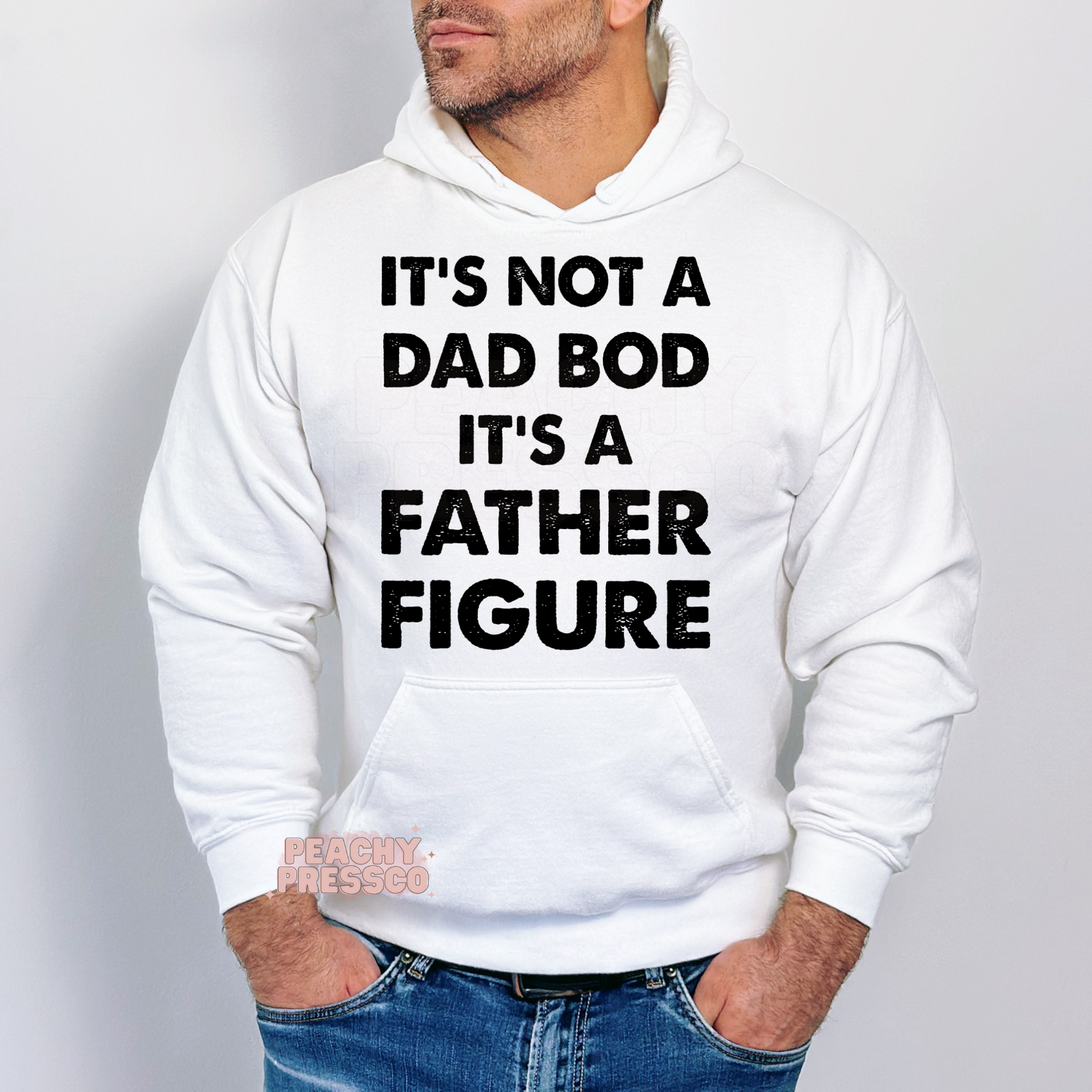 Man modeling white hoodie with funny dad bod quote graphic reading “It’s Not a Dad Bod It’s a Father Figure.”