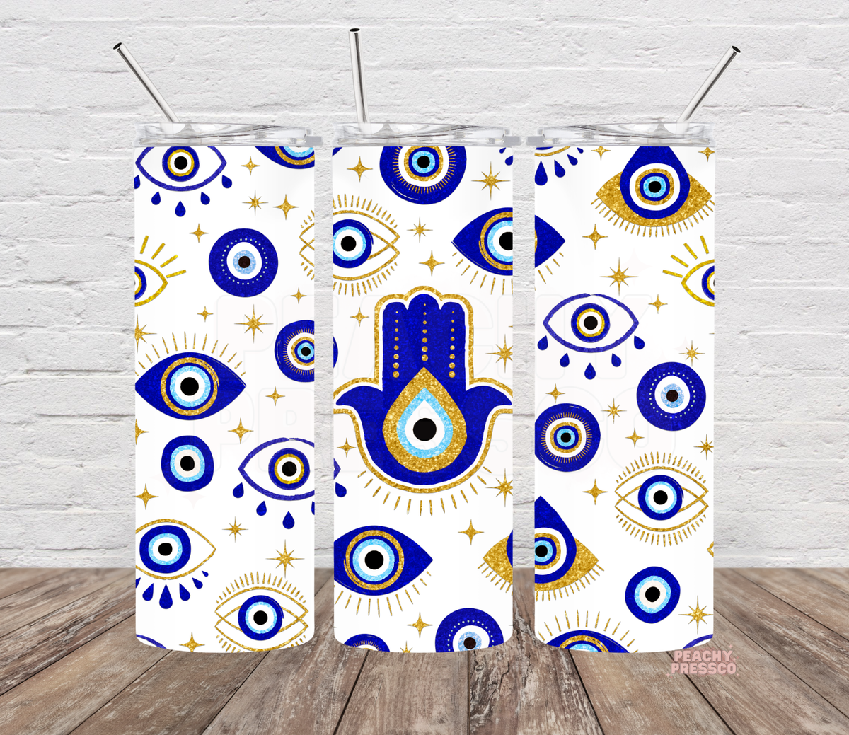 20 oz white skinny tumbler featuring royal blue evil eyes, gold stars, celestial accents and a large blue Hamsa hand with an eye in the center.