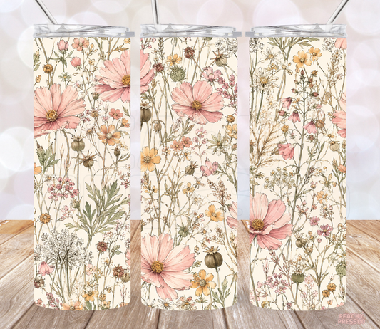 20 oz vintage floral skinny tumbler featuring blush pink cosmos flowers, peach wildflowers and delicate botanical stems on a cream background.