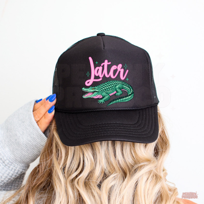 Black trucker hat with pink “Later” lettering and teal alligator design, perfect for summer vacations, lake life and casual everyday wear.