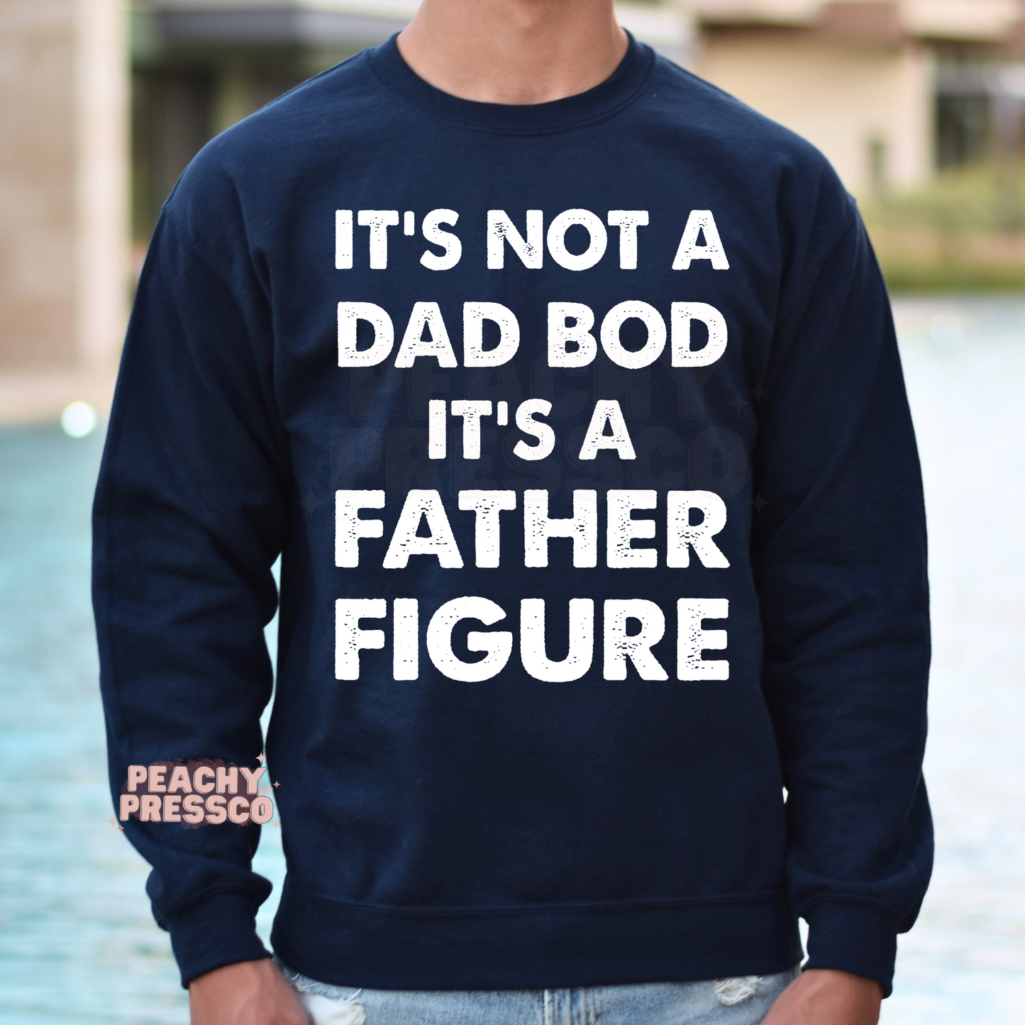 Man wearing navy crewneck sweatshirt with distressed white “Father Figure” dad quote graphic design.