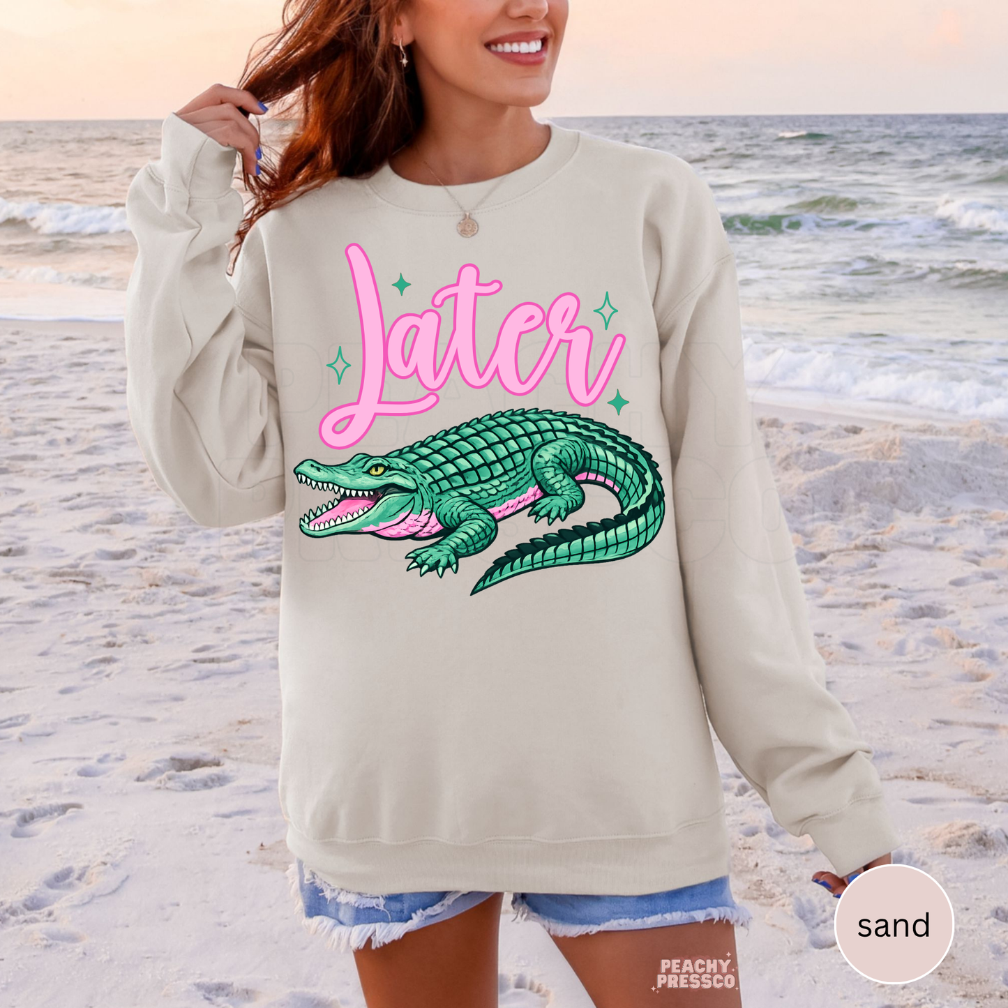 Sand crewneck sweatshirt featuring a retro pink “Later” graphic with teal alligator illustration – cute southern lake life sweatshirt for women.