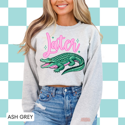 Ash grey crewneck sweatshirt with retro alligator design and pink “Later” typography – cute southern-inspired women’s sweatshirt.