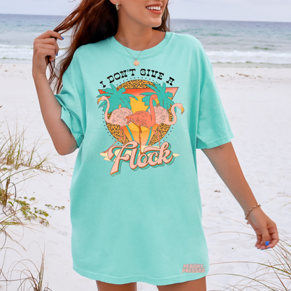 Woman wearing an island reef oversized beach t-shirt with vibrant flamingo graphic and tropical summer design.