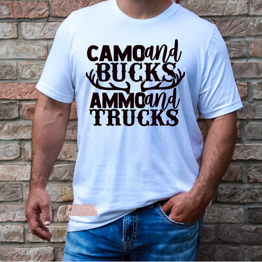 Man modeling white t-shirt with rustic hunting-themed “Camo and Bucks Ammo and Trucks” typography design.