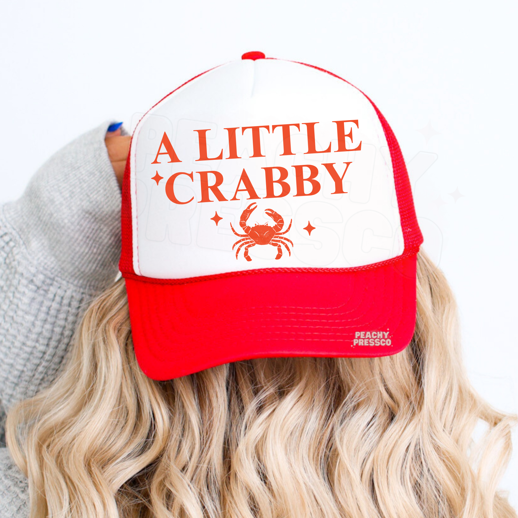 Red and white trucker hat with A Little Crabby graphic and crab illustration – cute coastal summer hat for beach trips, lake days and vacation outfits.