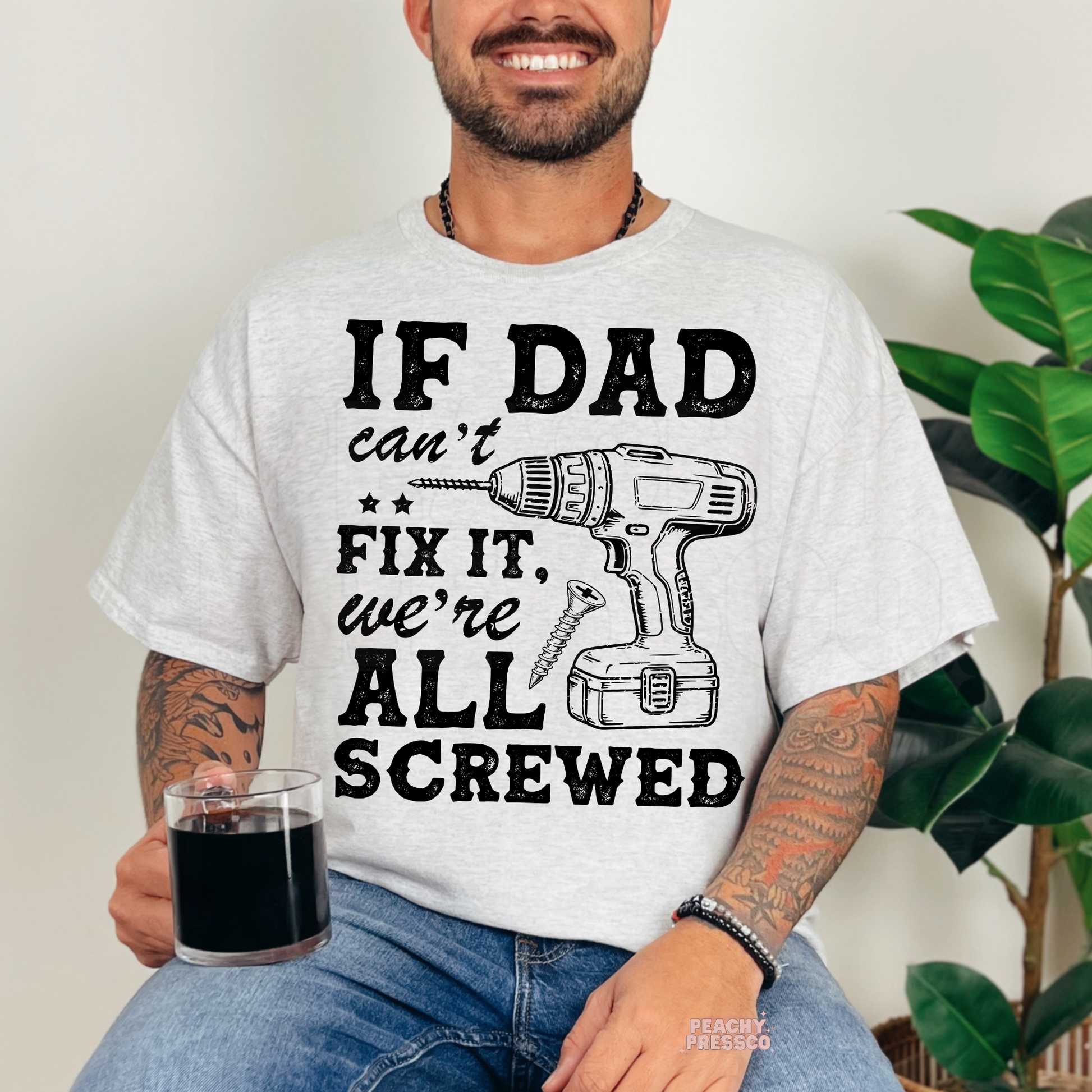 Man in ash grey t-shirt featuring funny dad mechanic quote with drill and screw illustration.