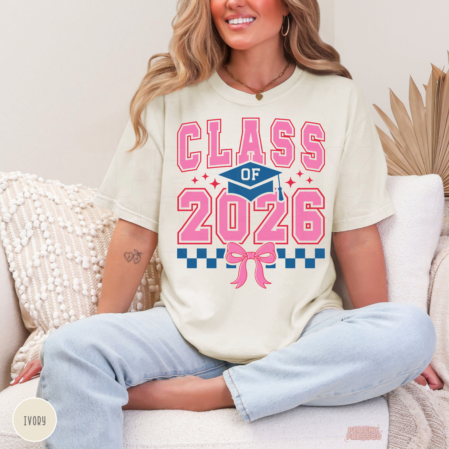 Cute Class of 2026 graduate shirt featuring coquette bow design, graduation cap graphic, and pink varsity text for grads.