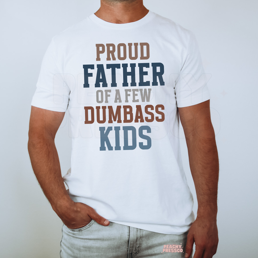 Man wearing white t-shirt with funny “Proud Father of a Few Dumbass Kids” typography graphic.
