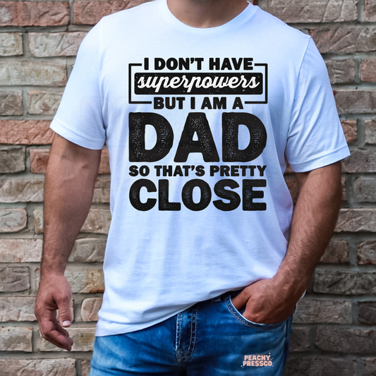 Man wearing white t-shirt with “I Don’t Have Superpowers But I Am A Dad” graphic text.