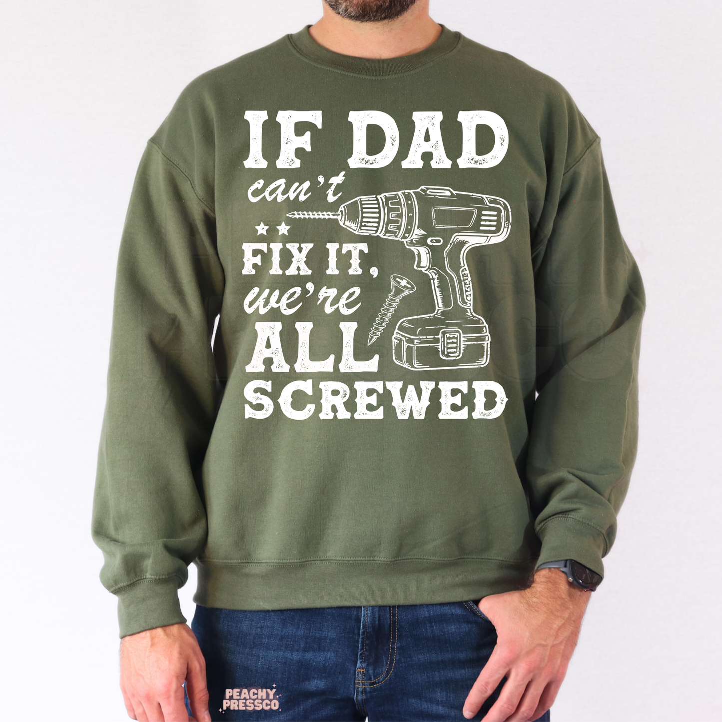 Man modeling military green crewneck sweatshirt with humorous dad repair quote and drill graphic design.