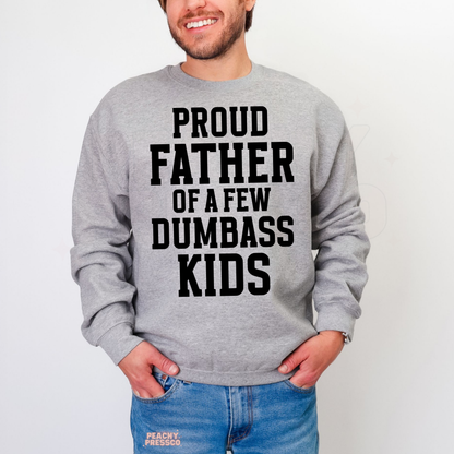 Man modeling grey crewneck sweatshirt featuring large black “Proud Father of a Few Dumbass Kids” slogan print.
