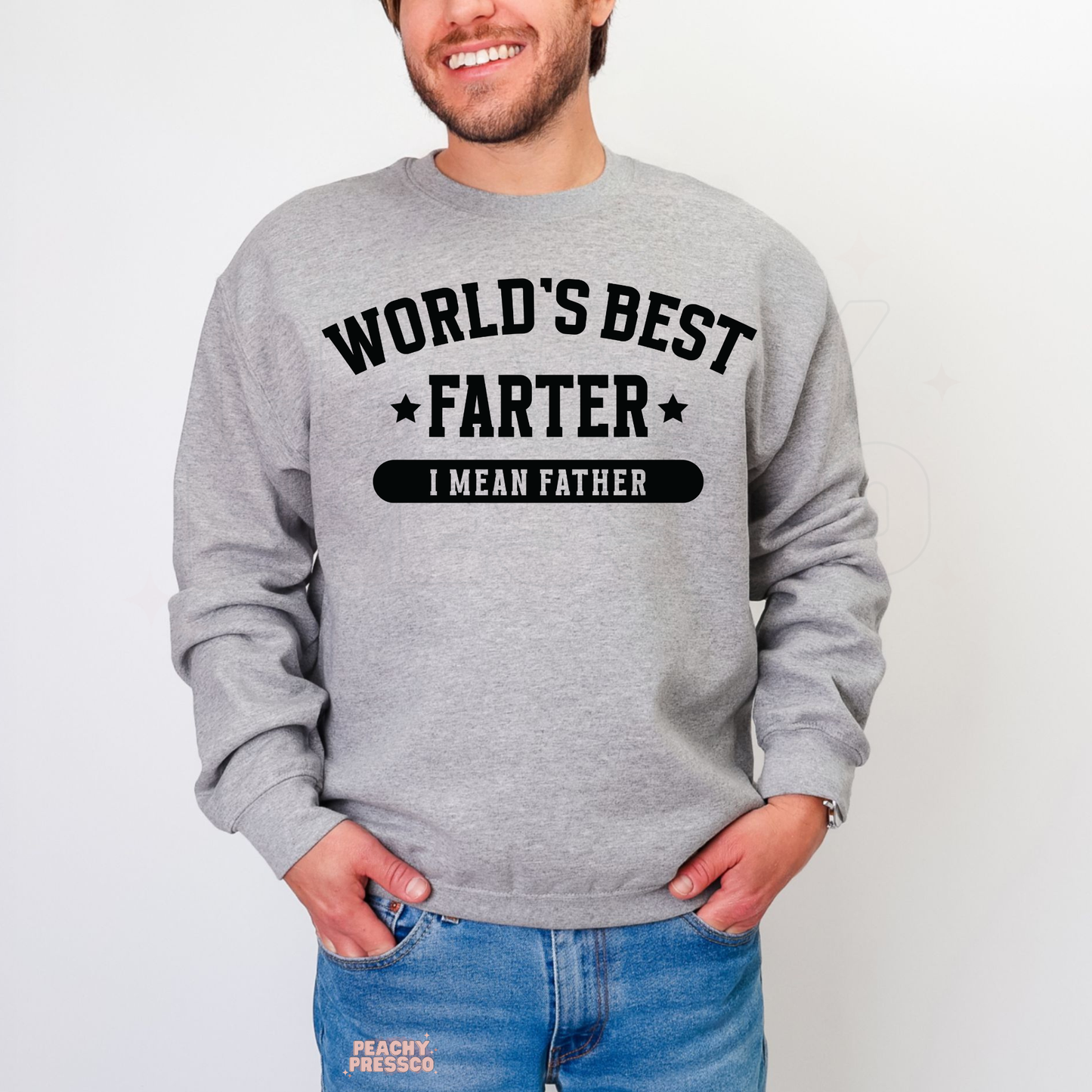 Man wearing grey crewneck sweatshirt with funny “World’s Best Farter I Mean Father” Father’s Day graphic design.
