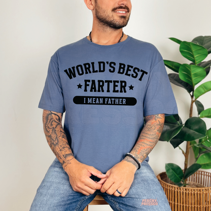 Man sitting on stool wearing blue t-shirt with humorous “World’s Best Farter I Mean Father” Father’s Day graphic.