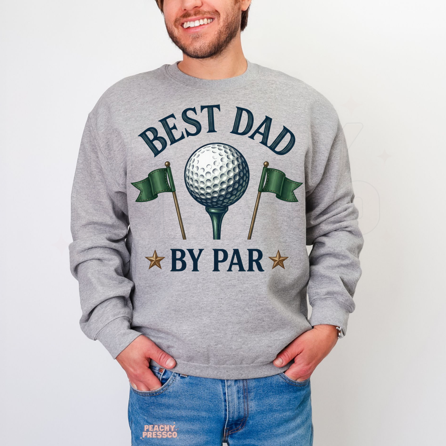 Man wearing grey crewneck sweatshirt with vintage golf-themed “Best Dad By Par” graphic featuring golf ball and flags.