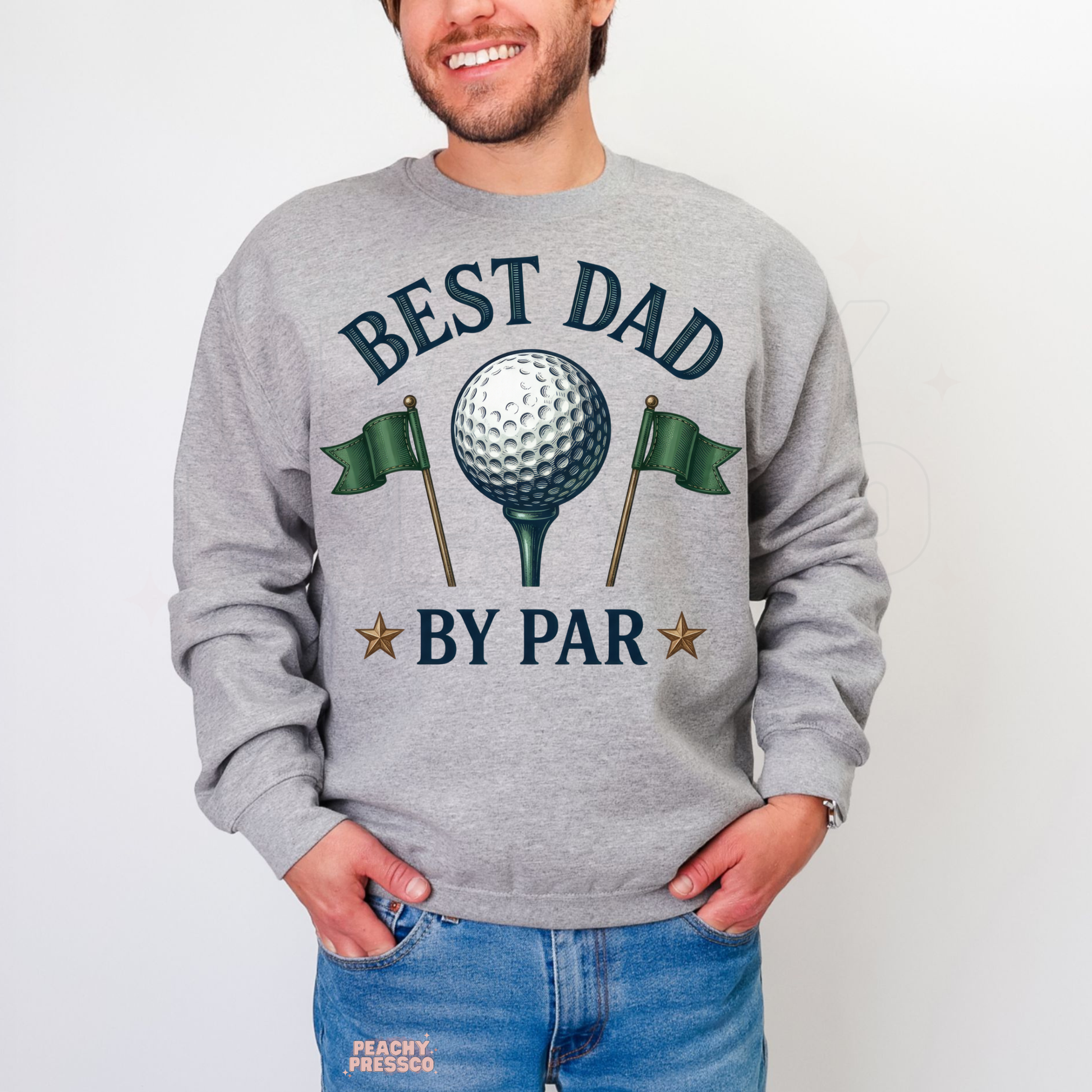 Man wearing grey crewneck sweatshirt with vintage golf-themed “Best Dad By Par” graphic featuring golf ball and flags.
