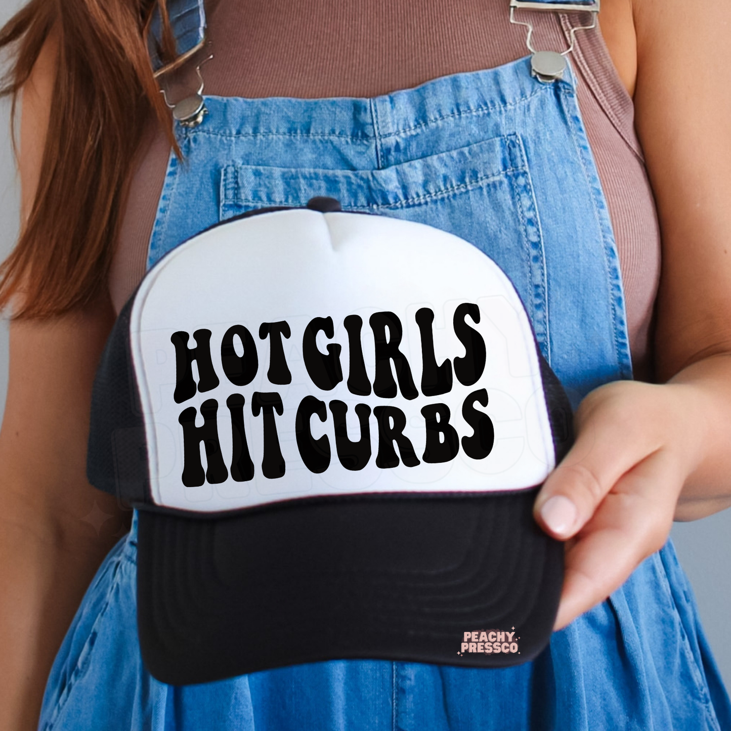 Black and white trucker hat featuring “Hot Girls Hit Curbs” text.
