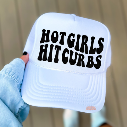 White trucker hat featuring “Hot Girls Hit Curbs” text.