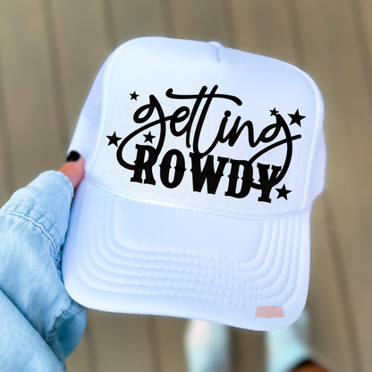 White trucker hat with “Get In Howdy” western typography.
