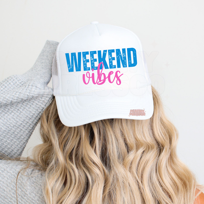 White trucker hat with Weekend Vibes design in distressed blue and pink lettering – cute summer trucker cap for beach days and lake life.