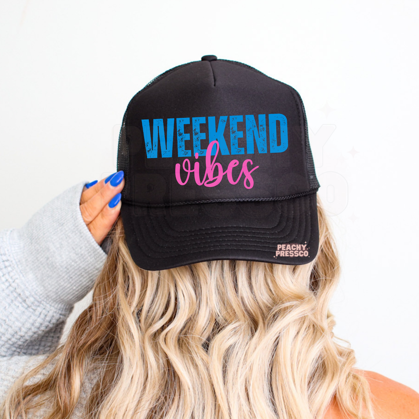 Women’s Weekend Vibes trucker cap featuring retro blue and pink text – stylish summer accessory for vacations, boating and everyday wear.