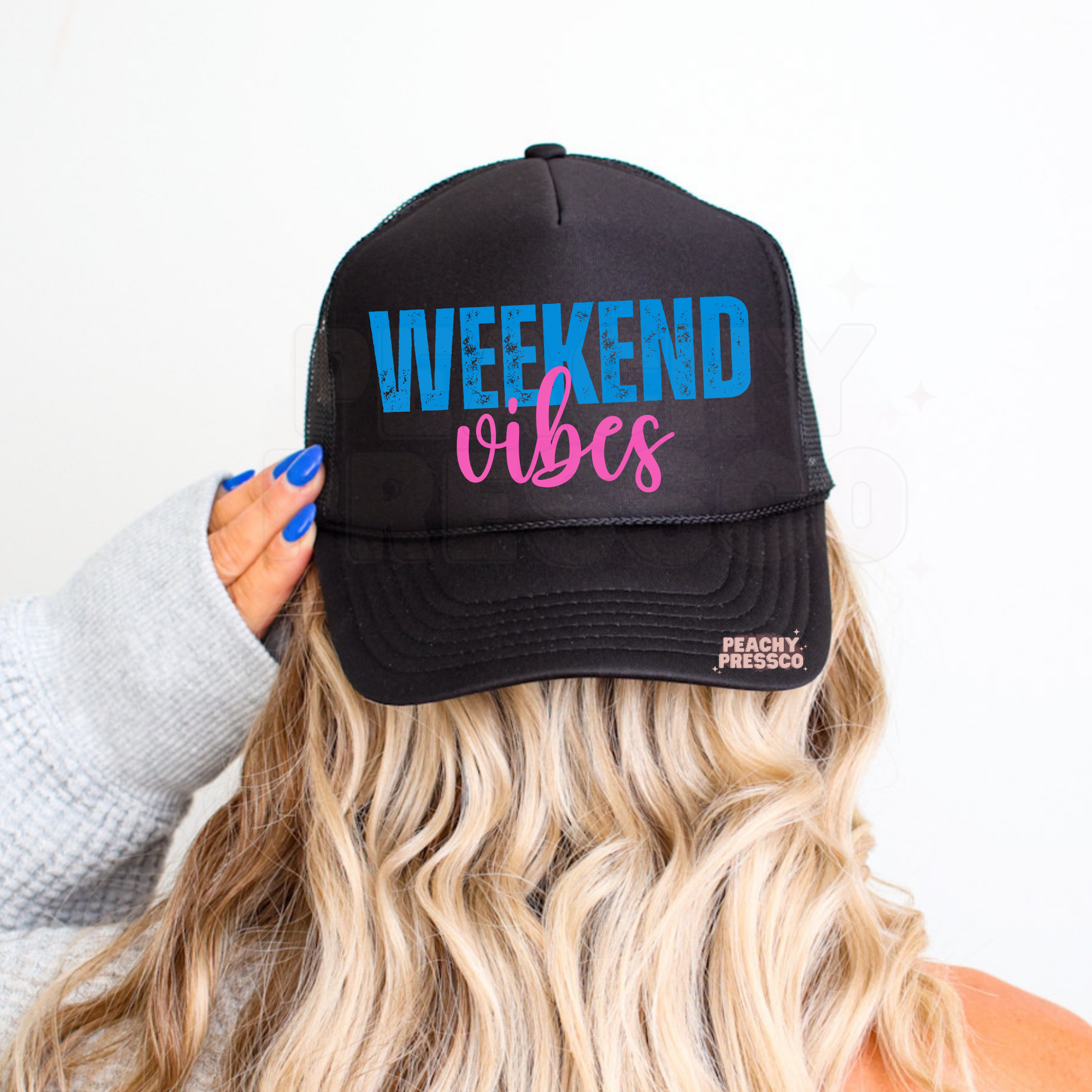 Women’s Weekend Vibes trucker cap featuring retro blue and pink text – stylish summer accessory for vacations, boating and everyday wear.