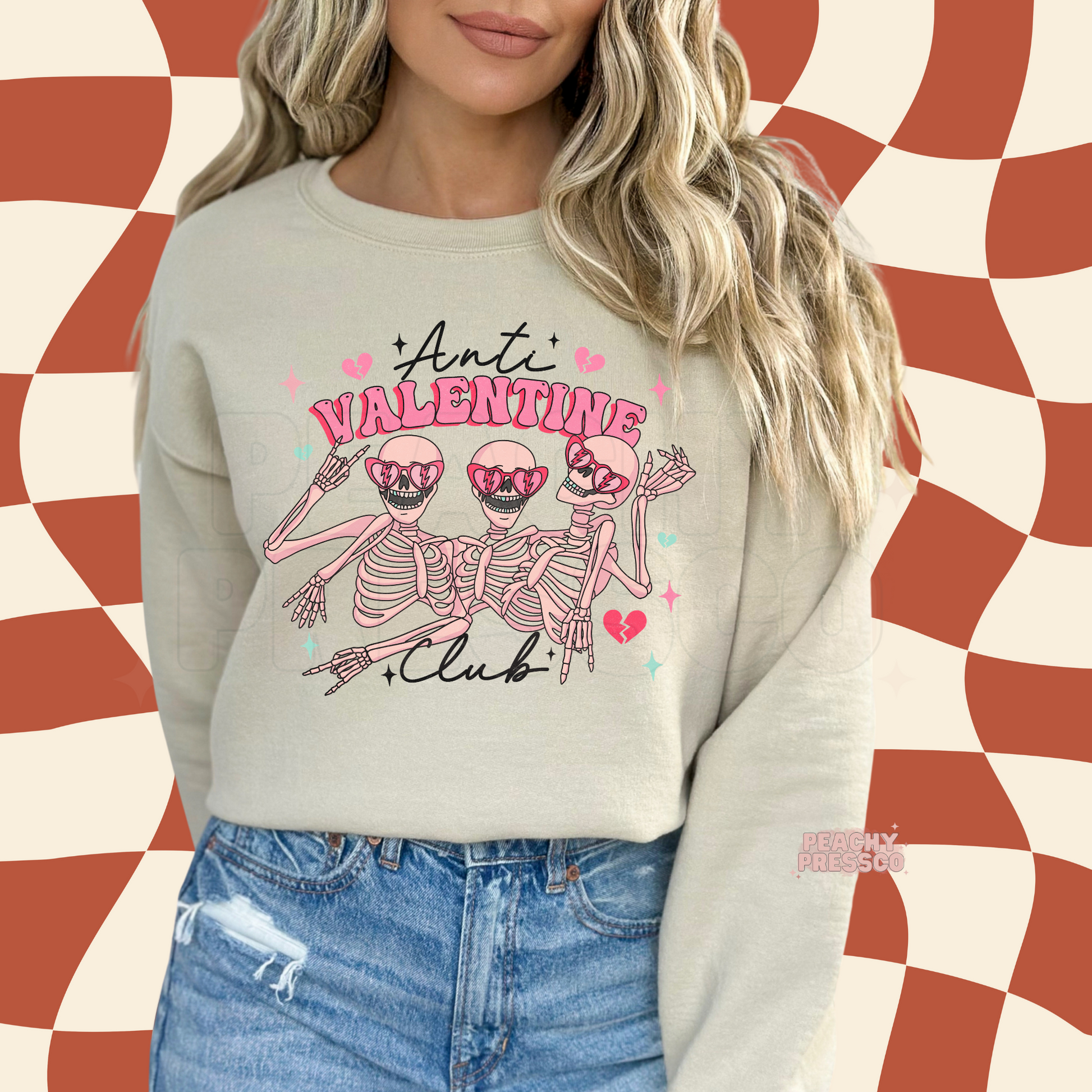 Sand crewneck sweatshirt with a retro Anti Valentine Club skeleton graphic, pink hearts, and playful Valentine's Day accents.