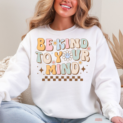 White Be Kind to Your Mind sweatshirt with colourful retro lettering, happy smiley face flowers, sparkling stars and a positive mental health message.