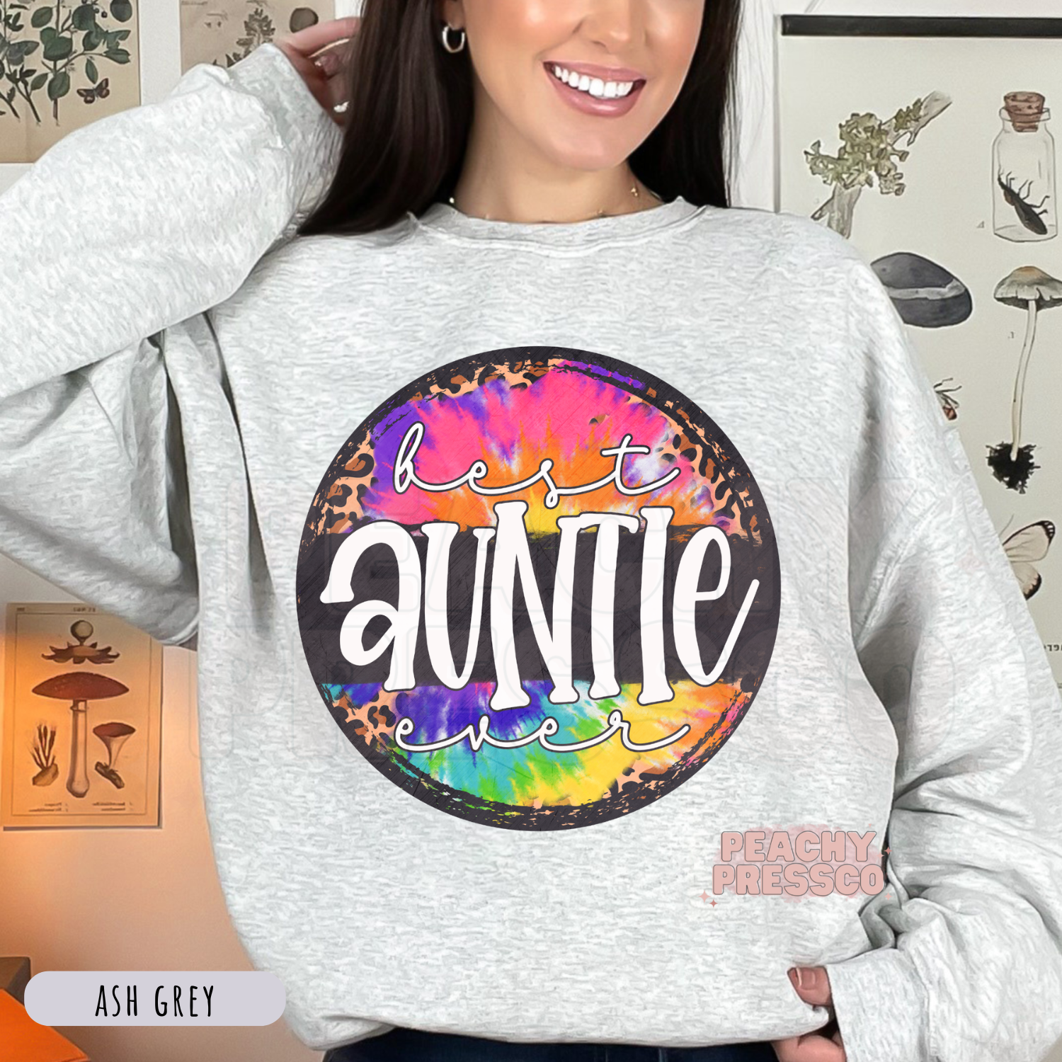 Ash Grey sweatshirt featuring a colorful tie-dye and leopard print "Best Auntie Ever" graphic. Comfortable family-themed sweatshirt for proud aunts.