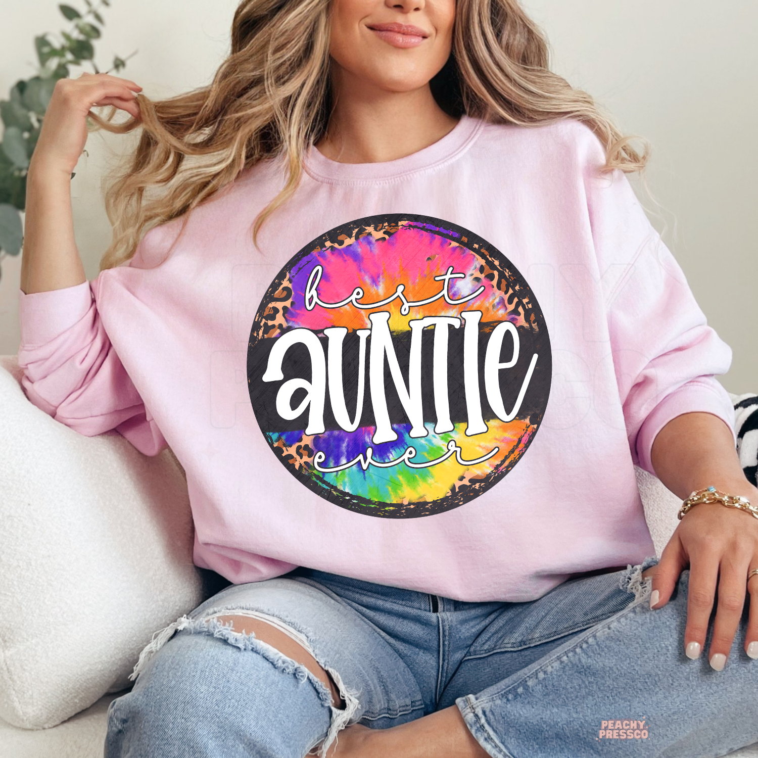 Light pink sweatshirt featuring a vibrant tie-dye and leopard print "Best Auntie Ever" graphic. Sweet and colorful gift for new or favorite aunts.