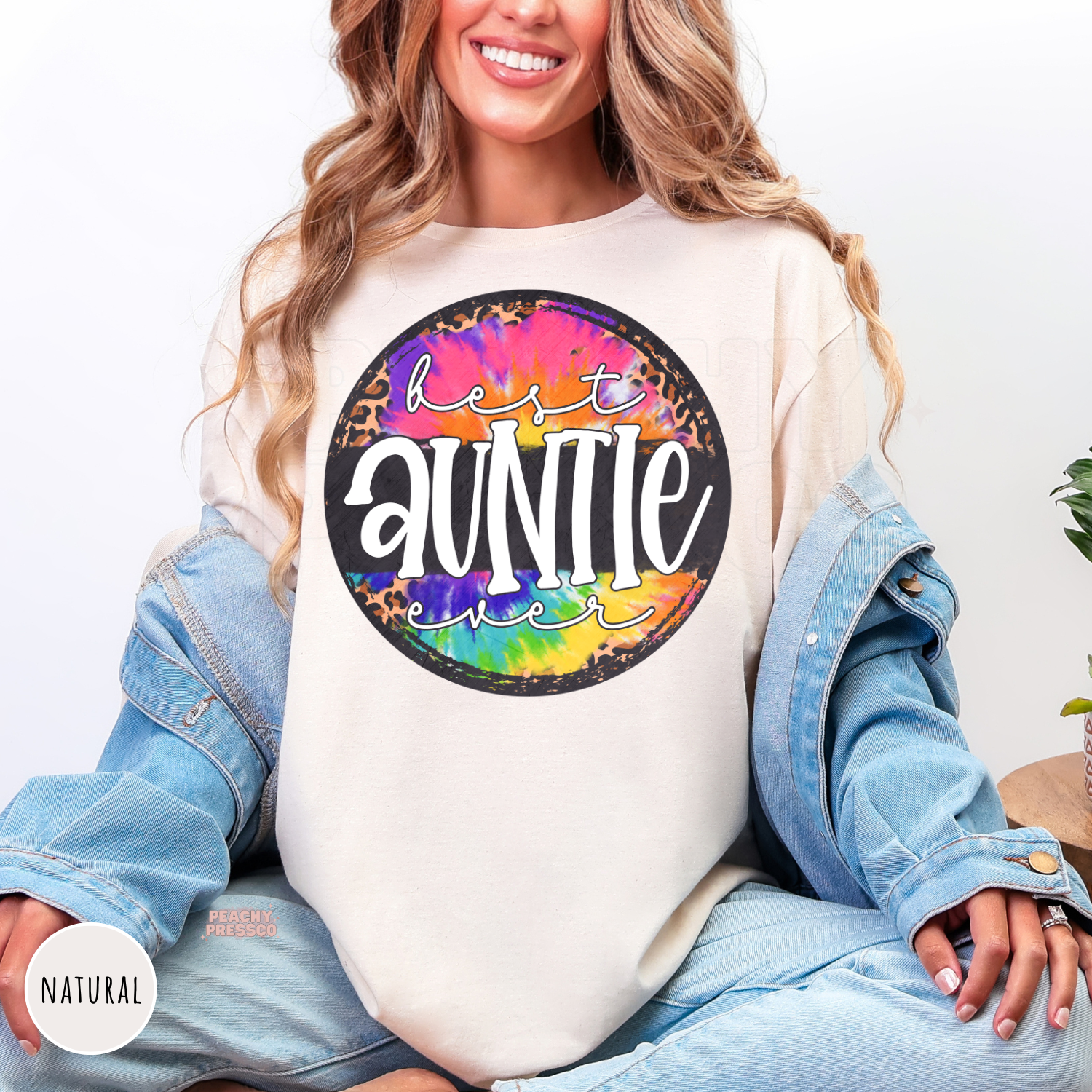 Natural shirt with a colorful tie-dye and leopard print "Best Auntie Ever" graphic. A cheerful and thoughtful gift for any proud aunt.