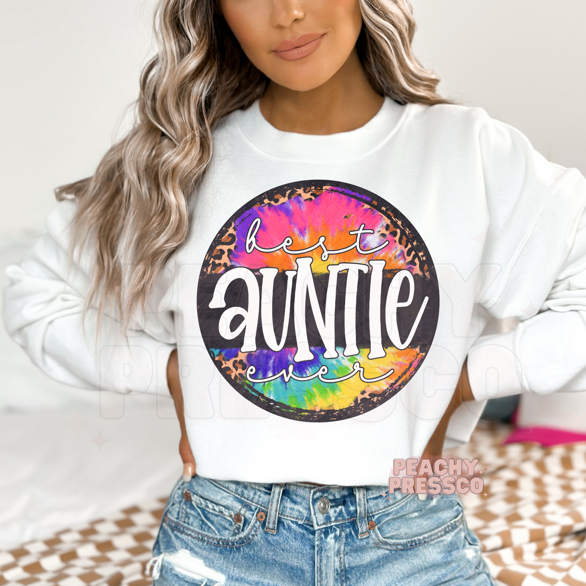 White sweatshirt featuring a colorful tie-dye and leopard print "Best Auntie Ever" graphic. Soft and trendy sweatshirt perfect for gifting your favorite aunt.