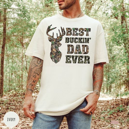 Ivory Comfort Colors t-shirt featuring a camouflage deer silhouette and Best Buckin' Dad Ever graphic, a thoughtful gift for dads who enjoy hunting.