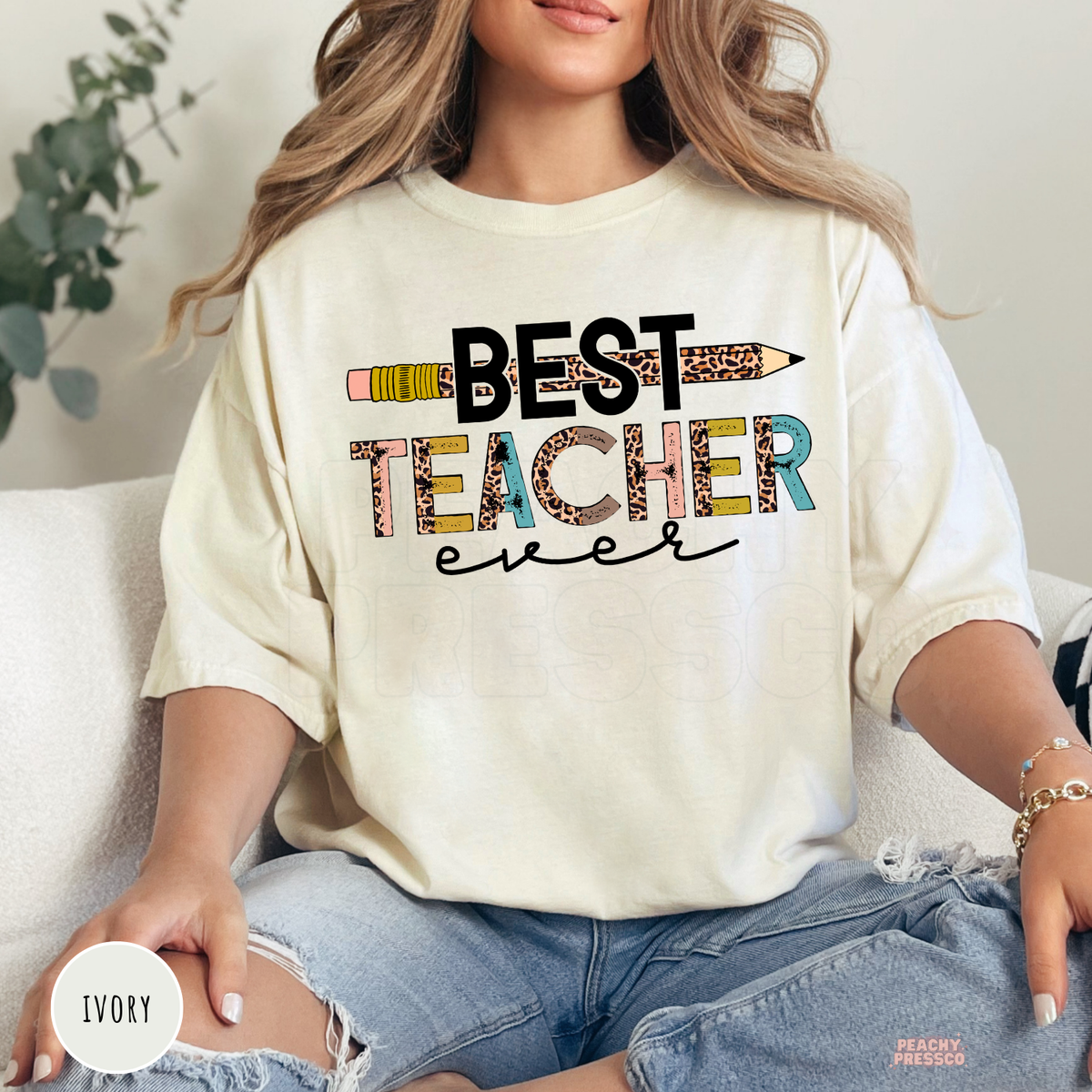 Ivory Comfort Colors teacher t-shirt with a "Best Teacher Ever" design featuring a leopard print pencil, colorful distressed typography, and modern classroom style.