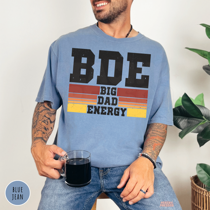 Blue Jean Comfort Colors t-shirt featuring the Big Dad Energy design with distressed lettering and retro sunset stripes, perfect for Father's Day.