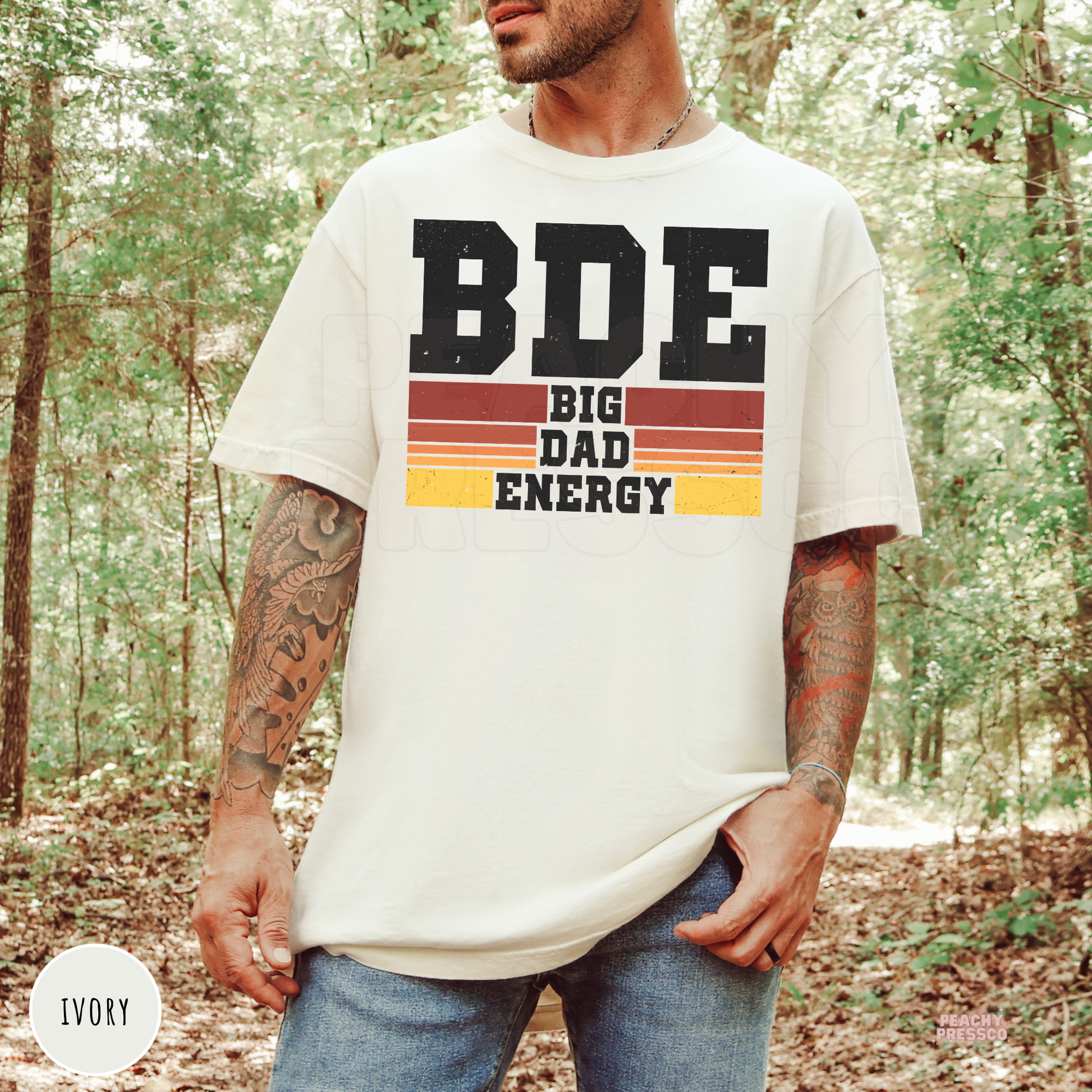 Ivory Comfort Colors t-shirt featuring the Big Dad Energy graphic with distressed lettering and retro sunset stripes, a stylish gift for fathers.