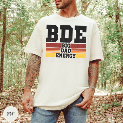 Ivory Comfort Colors t-shirt featuring the Big Dad Energy graphic with distressed lettering and retro sunset stripes, a stylish gift for fathers.