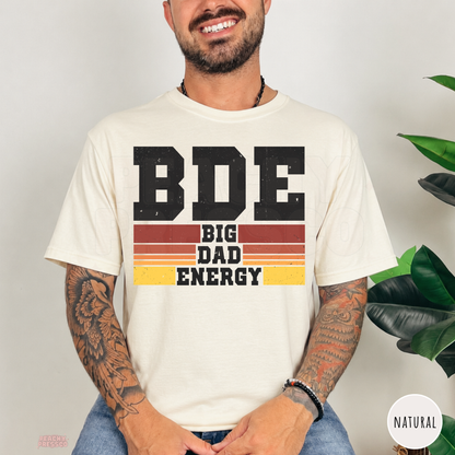 Natural t-shirt featuring the Big Dad Energy graphic with distressed black lettering and retro sunset stripes, a casual gift for dads.