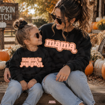 Matching black Mama and Mama's Pumpkin sweatshirts for mom and daughter at a pumpkin patch, perfect for fall family photos.