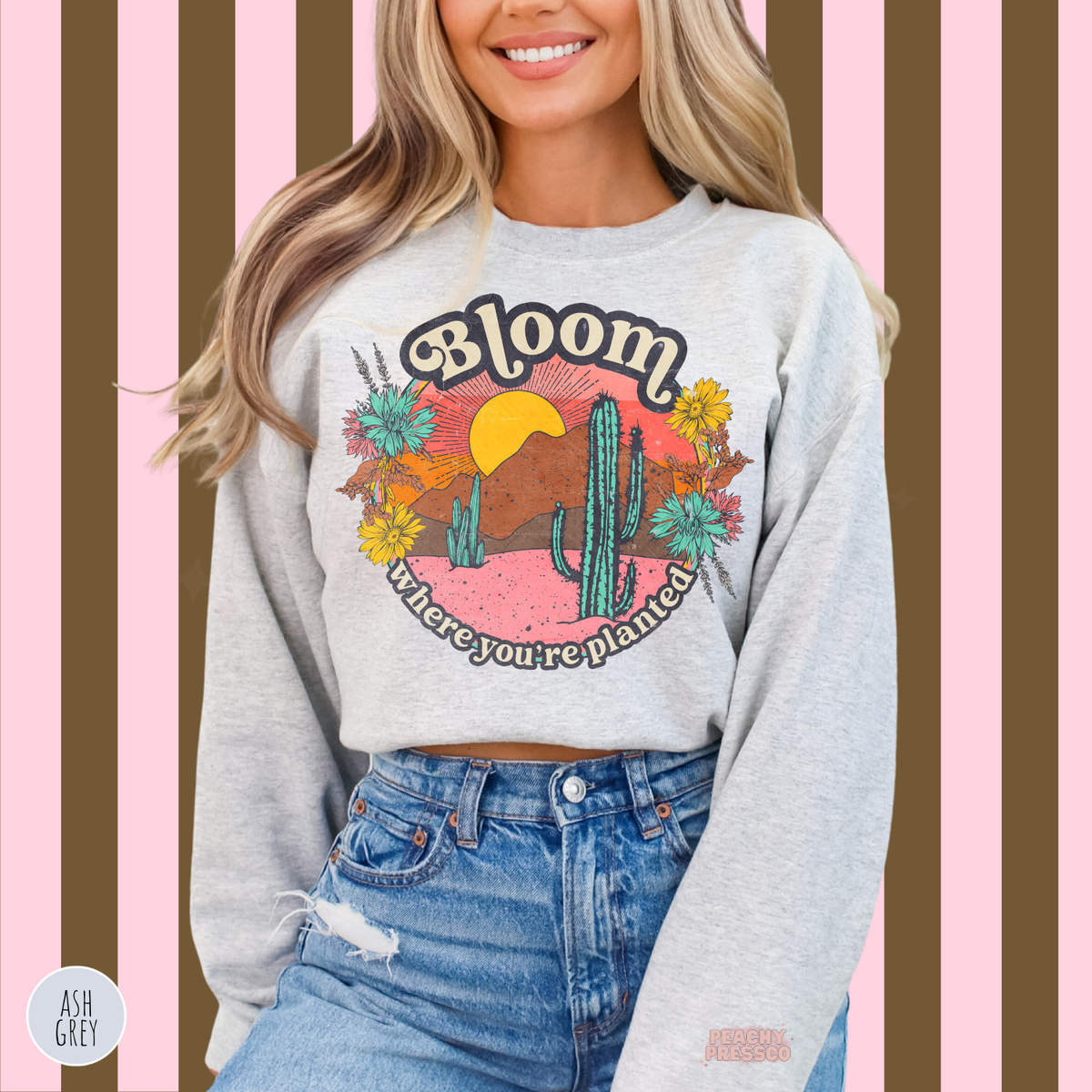 Ash grey Bloom Where You're Planted sweatshirt with a retro cactus and wildflower graphic, colorful desert sunset, and uplifting inspirational quote.