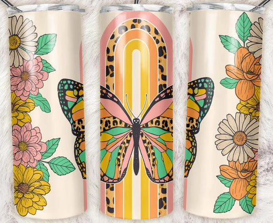 20 oz skinny tumbler featuring a colorful butterfly with retro rainbow stripes, leopard print accents, and floral details. Bright boho tumbler with clear lid and straw.