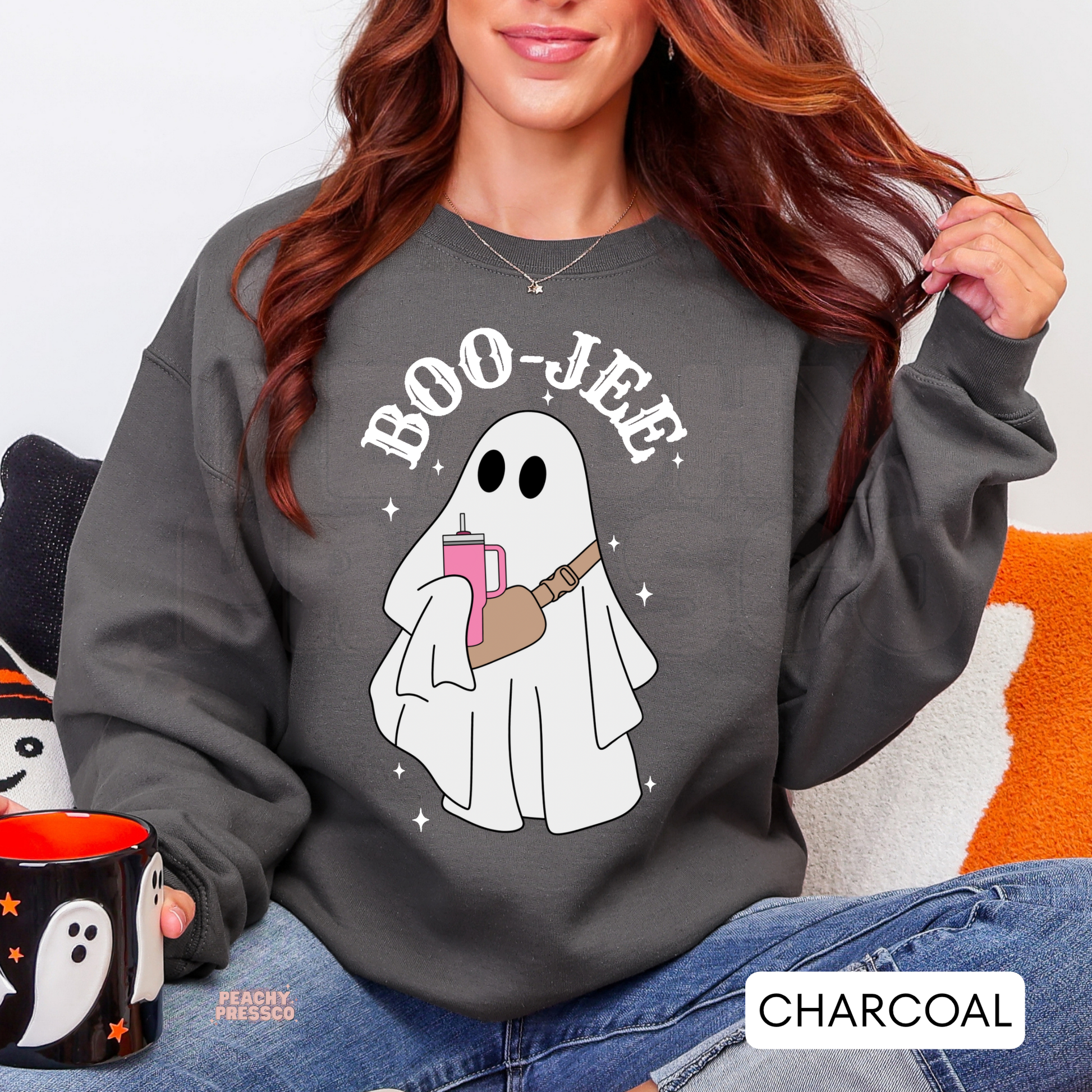Woman wearing a charcoal Boo-Jee ghost crewneck sweatshirt featuring a cute ghost with pink tumbler.