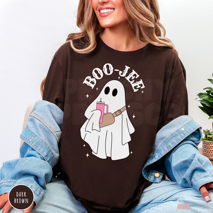 Woman wearing a dark brown Boo-Jee ghost Halloween shirt with trendy ghost graphic holding a pink tumbler.