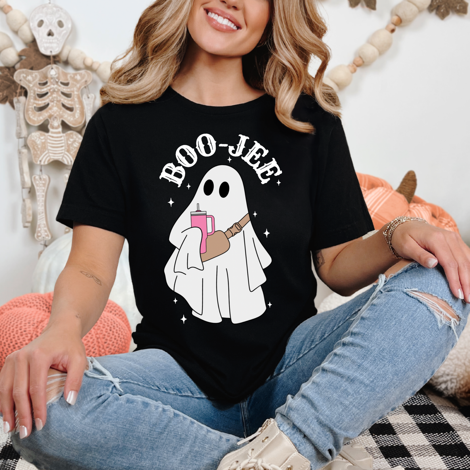 Woman wearing a black Boo-Jee ghost Halloween t-shirt featuring a cute ghost with tumbler and crossbody bag.